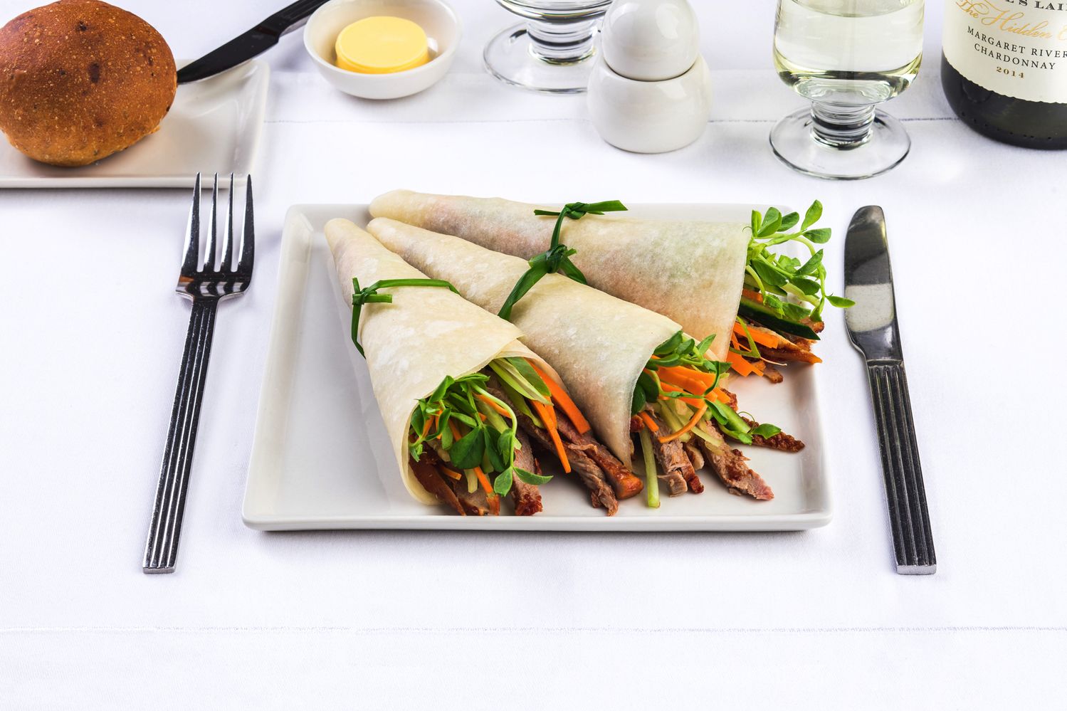 Peking duck pancakes with Hoisin sauce: locally-sourced duck is roasted and thinly sliced, with spring onion, snow pea sprouts and thinly-sliced carrot, wrapped in a traditional Chinese pancake. Served with Hoisin sauce.
